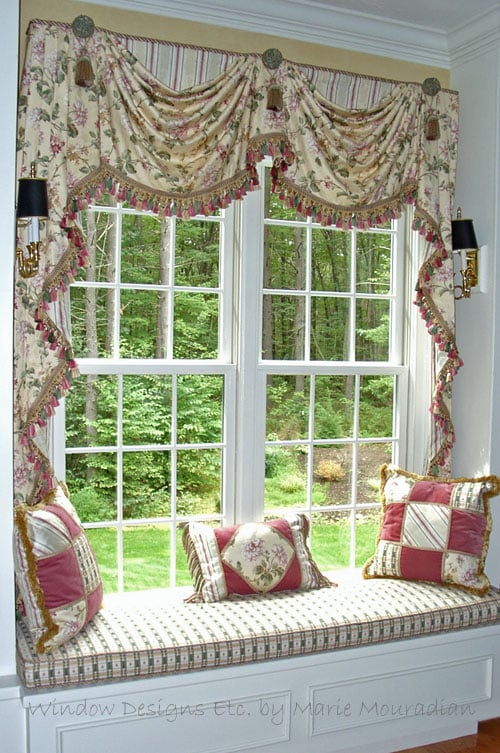 Custom window seat framed with swags and cascades, window seat cushion and decorative pillows